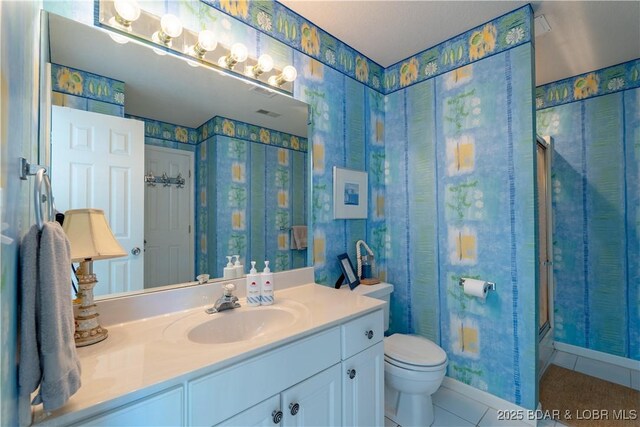 full bath featuring tile patterned flooring, vanity, toilet, and wallpapered walls