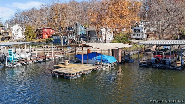 279 Spring Rd, Lake Ozark, MO 65049 - dock area with boat lift, a water view, and a residential view