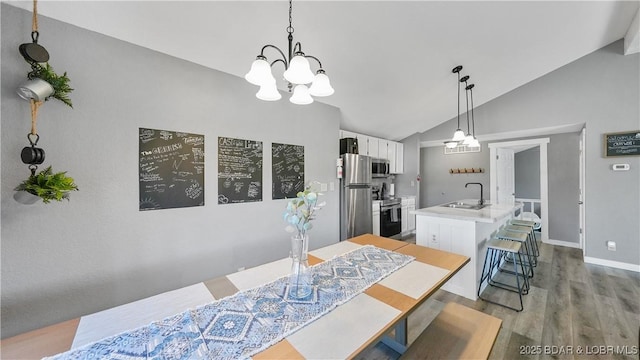 279 Spring Rd, Lake Ozark, MO 65049 - dining room featuring a chandelier, vaulted ceiling, light wood-type flooring, and baseboards