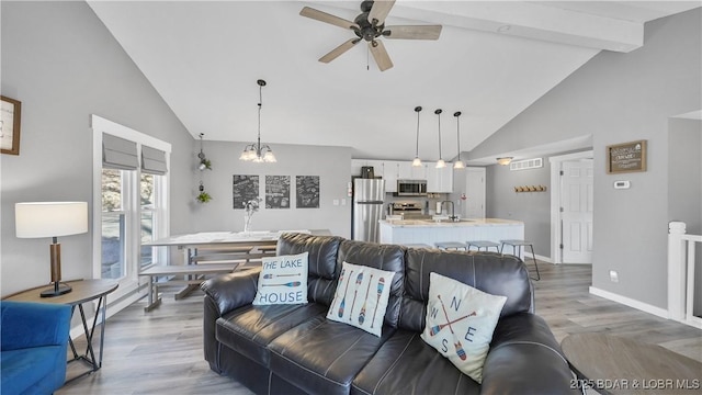 279 Spring Rd, Lake Ozark, MO 65049 - living room with high vaulted ceiling, ceiling fan, wood finished floors, beamed ceiling, and baseboards