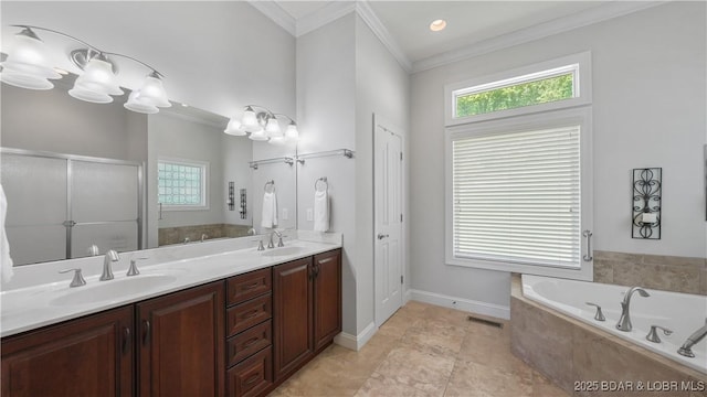 bathroom with crown molding, a bath, a shower stall, double vanity, and baseboards