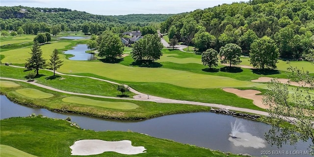 surrounding community with a water view, a view of trees, and view of golf course