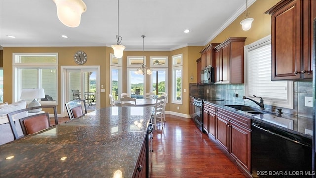kitchen featuring black appliances, backsplash, pendant lighting, a chandelier, and dark wood finished floors