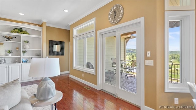 entryway featuring crown molding, hardwood / wood-style floors, baseboards, and recessed lighting