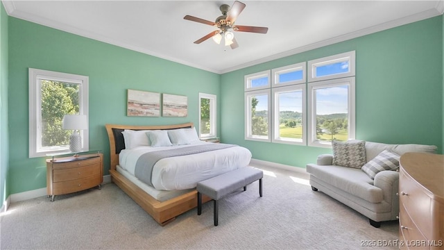 bedroom with ornamental molding, baseboards, light colored carpet, and ceiling fan
