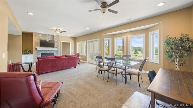 dining area with a ceiling fan, light colored carpet, a fireplace, recessed lighting, and baseboards