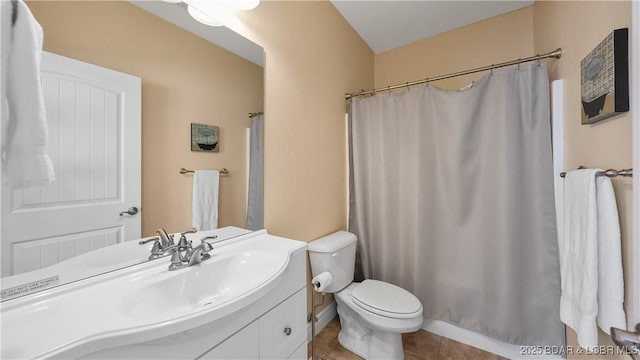 bathroom featuring toilet, vanity, a shower with curtain, and tile patterned flooring