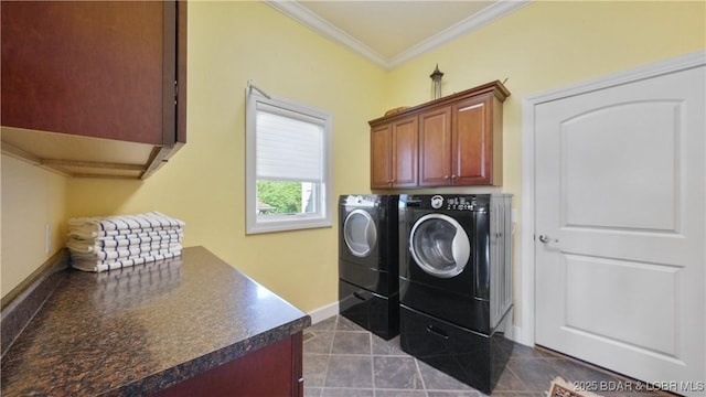laundry room with independent washer and dryer, cabinet space, ornamental molding, dark tile patterned floors, and baseboards