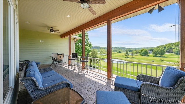 view of patio / terrace with ceiling fan and golf course view