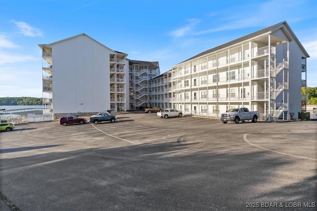 view of apartment building / complex featuring uncovered parking