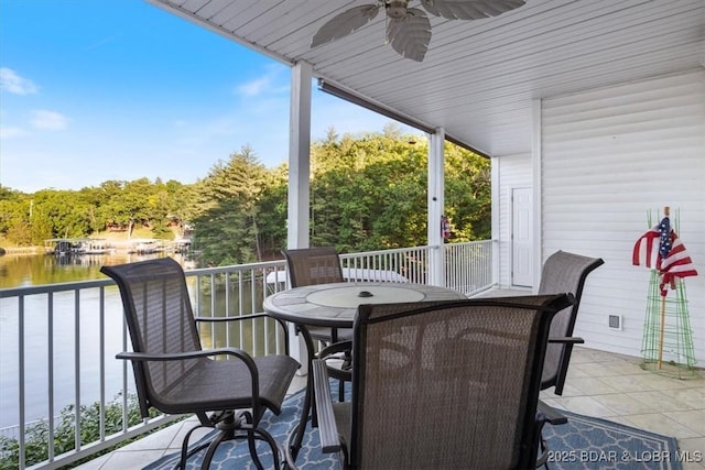 view of patio with a ceiling fan, a water view, and outdoor dining area