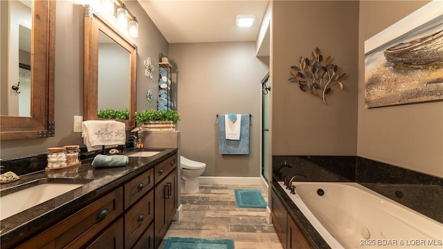 full bath with a bath, wood finished floors, toilet, and double vanity