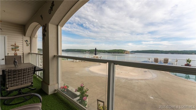 balcony featuring a water view