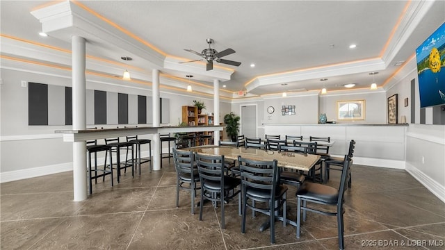 dining space featuring a tray ceiling, ceiling fan, crown molding, recessed lighting, and baseboards