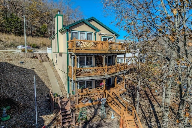 27085 Dixie Ln, Barnett, MO 65011 - back of house featuring a balcony, stairs, a chimney, and a wooden deck