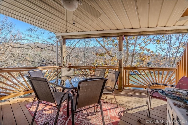27085 Dixie Ln, Barnett, MO 65011 - deck featuring outdoor dining space, a ceiling fan, and a mountain view