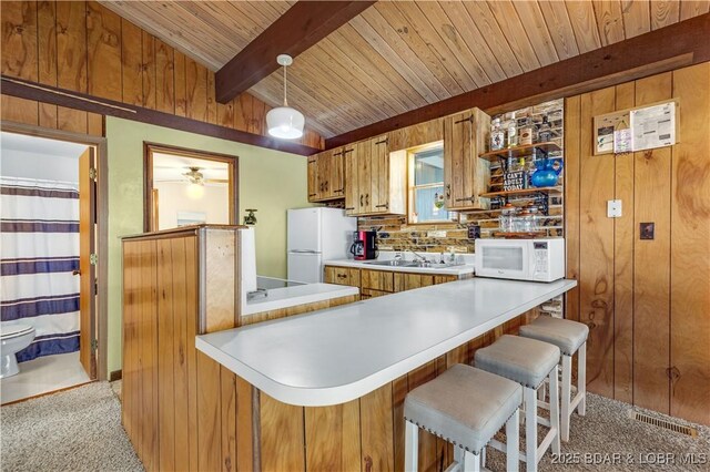 424 Bowers Dr, Camdenton, MO 65020 - kitchen with white appliances, light colored carpet, a wooden ceiling with exposed beams, brown cabinetry, and light countertops