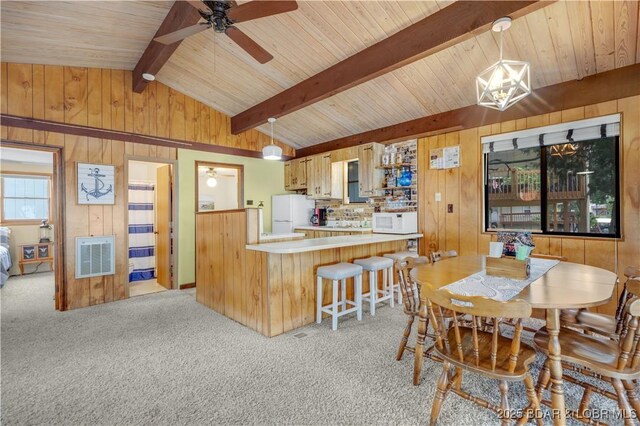 424 Bowers Dr, Camdenton, MO 65020 - dining room with ceiling fan, light carpet, wooden walls, wooden ceiling, and heating unit