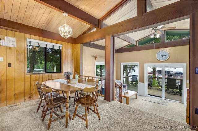 424 Bowers Dr, Camdenton, MO 65020 - dining room featuring carpet flooring, a chandelier, wooden walls, and ceiling fan