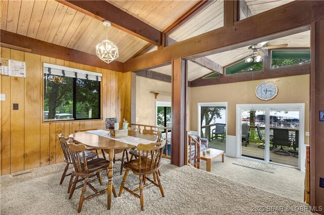 424 Bowers Dr, Camdenton, MO 65020 - dining space featuring carpet, a chandelier, wood walls, and ceiling fan