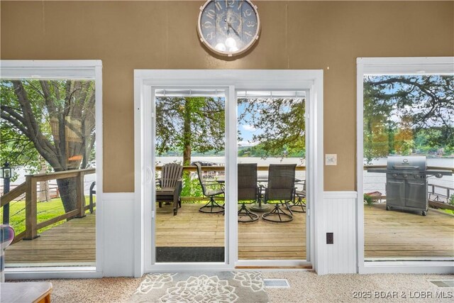424 Bowers Dr, Camdenton, MO 65020 - doorway to outside with a decorative wall, a wainscoted wall, and plenty of natural light