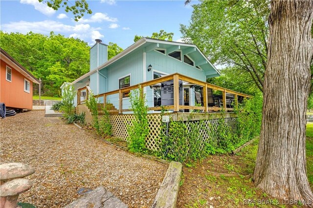 424 Bowers Dr, Camdenton, MO 65020 - view of front facade featuring a chimney and a wooden deck