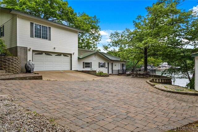 12 Mimosa Rd, Rocky Mount, MO 65072 - view of front facade featuring decorative driveway and a garage