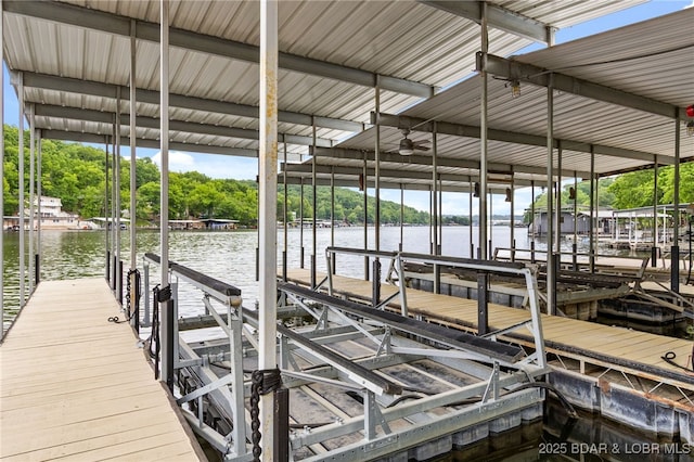 12 Mimosa Rd, Rocky Mount, MO 65072 - dock area featuring boat lift, a water view, and view of scattered trees