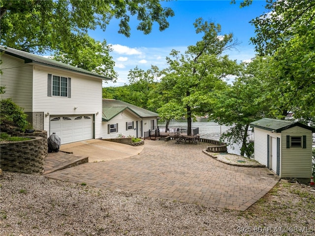 12 Mimosa Rd, Rocky Mount, MO 65072 - view of yard with an attached garage, concrete driveway, a storage shed, and an outdoor structure