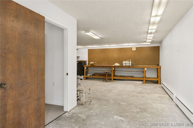 12 Mimosa Rd, Rocky Mount, MO 65072 - basement with a baseboard radiator, a workshop area, and a textured ceiling