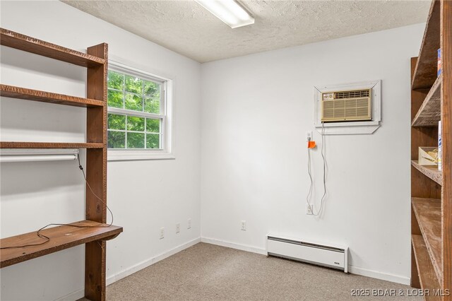 12 Mimosa Rd, Rocky Mount, MO 65072 - unfurnished bedroom with baseboard heating, an AC wall unit, a textured ceiling, carpet floors, and baseboards