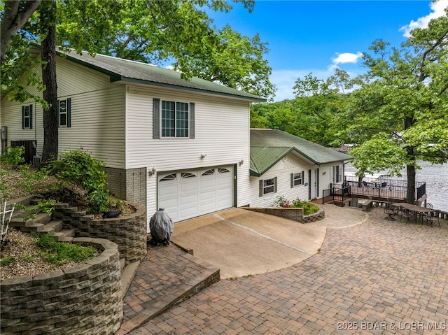 12 Mimosa Rd, Rocky Mount, MO 65072 - view of front of property with an attached garage, driveway, and a wooden deck