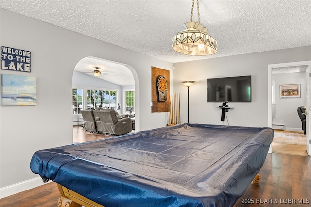 12 Mimosa Rd, Rocky Mount, MO 65072 - recreation room featuring arched walkways, a textured ceiling, billiards table, wood finished floors, and a baseboard radiator