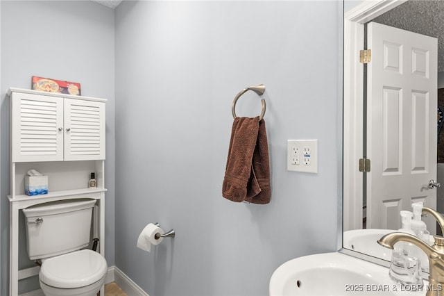 12 Mimosa Rd, Rocky Mount, MO 65072 - half bath featuring toilet, a sink, and baseboards