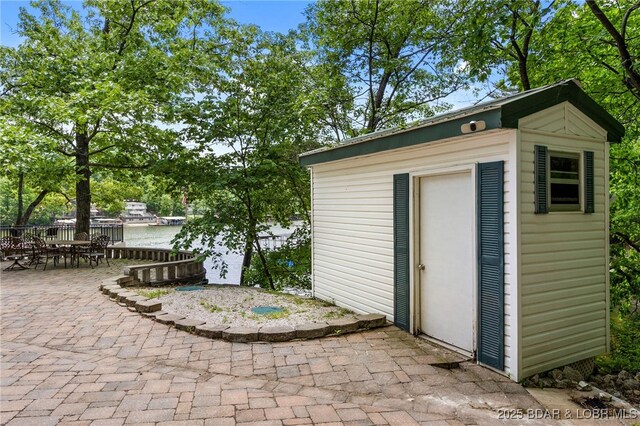 12 Mimosa Rd, Rocky Mount, MO 65072 - view of outdoor structure with an outbuilding, outdoor dining space, and a water view
