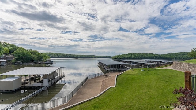 dock area featuring a water view and a yard