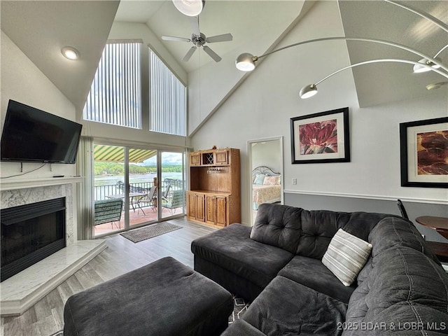 172 Cedar Glen Dr Unit 4B, Camdenton, MO 65020 - living area with ceiling fan, wood finished floors, high vaulted ceiling, a fireplace, and a water view
