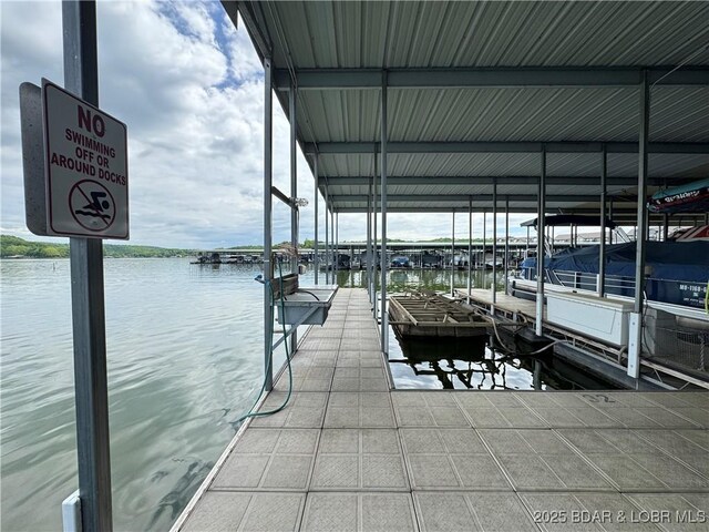 172 Cedar Glen Dr Unit 4B, Camdenton, MO 65020 - dock area featuring a water view and boat lift