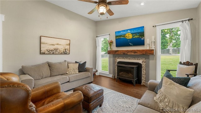 living room with a ceiling fan, wood finished floors, and healthy amount of natural light