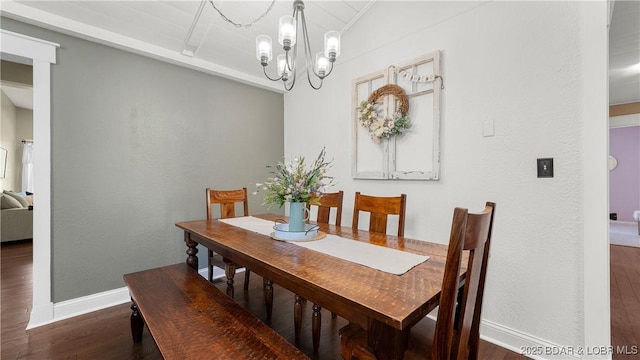 dining area featuring wood finished floors, baseboards, and a chandelier