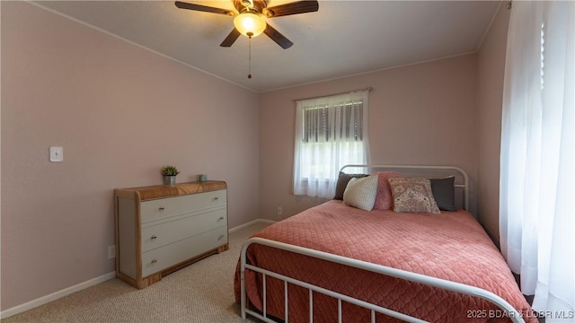 bedroom with light carpet, baseboards, crown molding, and a ceiling fan