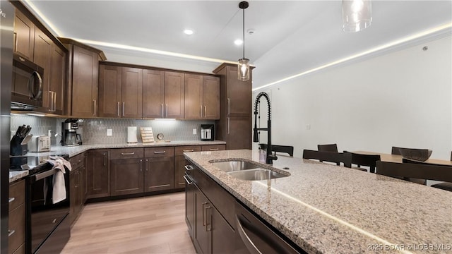 1045 Topsider Ln Unit 314, Osage Beach, MO 65065 - kitchen featuring a sink, black appliances, light wood-style floors, decorative light fixtures, and decorative backsplash
