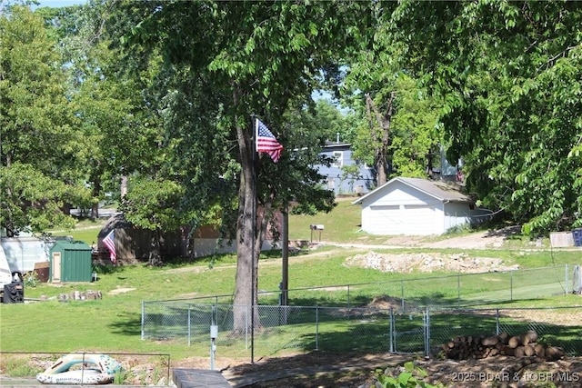 view of yard featuring an outbuilding and a garage