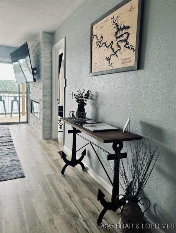 1481 Ledges Dr Unit 1019, Osage Beach, MO 65065 - home office featuring a textured wall, wood finished floors, and baseboards