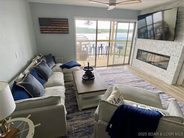 1481 Ledges Dr Unit 1019, Osage Beach, MO 65065 - living room with wood finished floors, ceiling fan, and a large fireplace