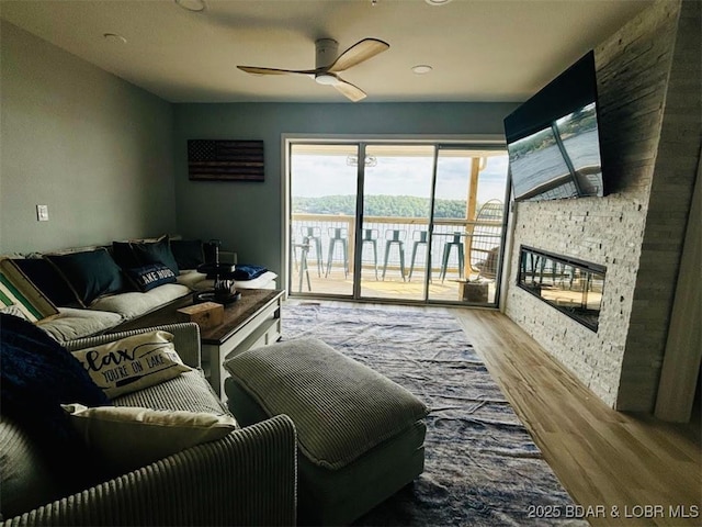 1481 Ledges Dr Unit 1019, Osage Beach, MO 65065 - living area featuring a ceiling fan, wood finished floors, and a fireplace