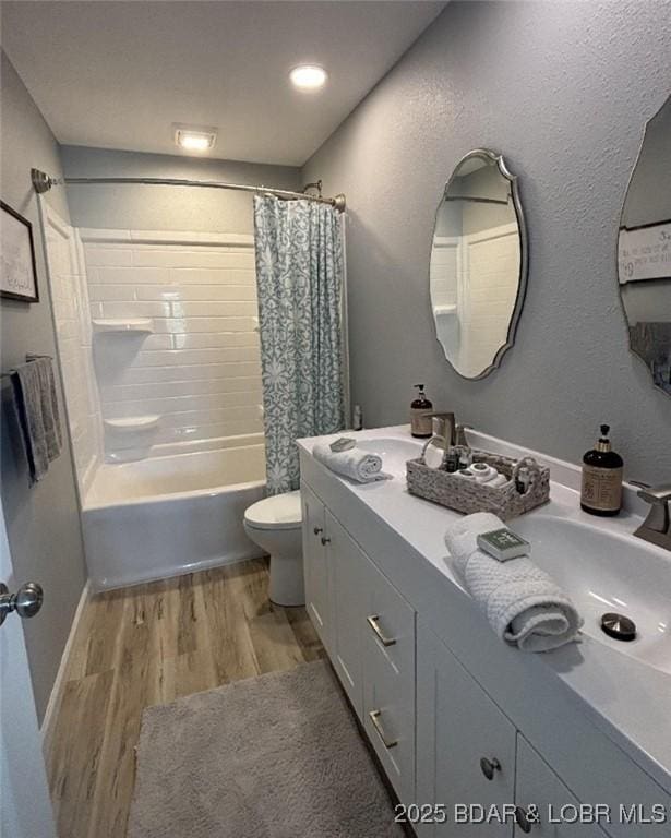 1481 Ledges Dr Unit 1019, Osage Beach, MO 65065 - bathroom featuring wood finished floors, toilet, shower / tub combo with curtain, and double vanity