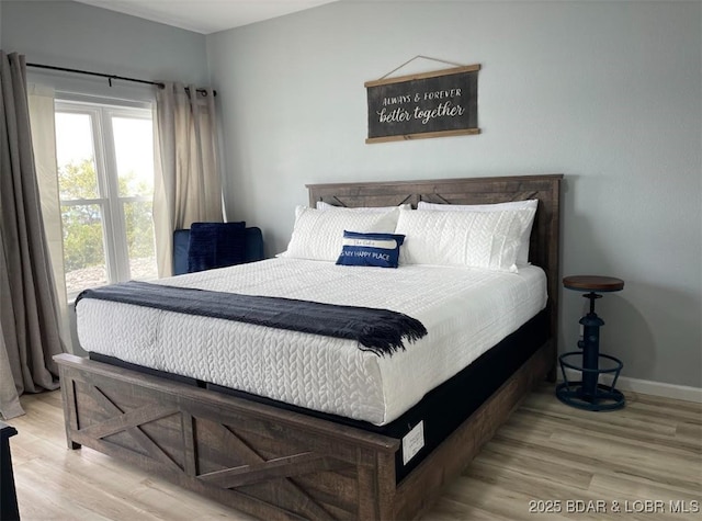 1481 Ledges Dr Unit 1019, Osage Beach, MO 65065 - bedroom with wood finished floors and baseboards