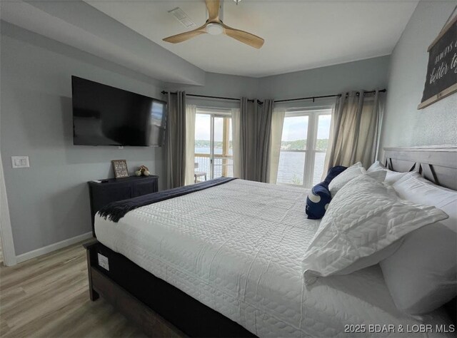 1481 Ledges Dr Unit 1019, Osage Beach, MO 65065 - bedroom with light wood finished floors, ceiling fan, and baseboards