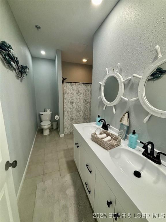 1481 Ledges Dr Unit 1019, Osage Beach, MO 65065 - bathroom featuring toilet, tile patterned floors, curtained shower, double vanity, and recessed lighting